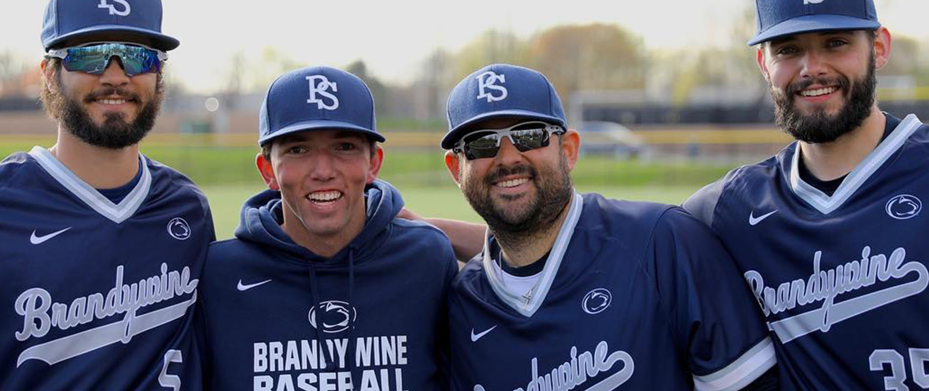 Penn State Brandywine's Eddie Caufield (second from left) poses with coaches and teammates.