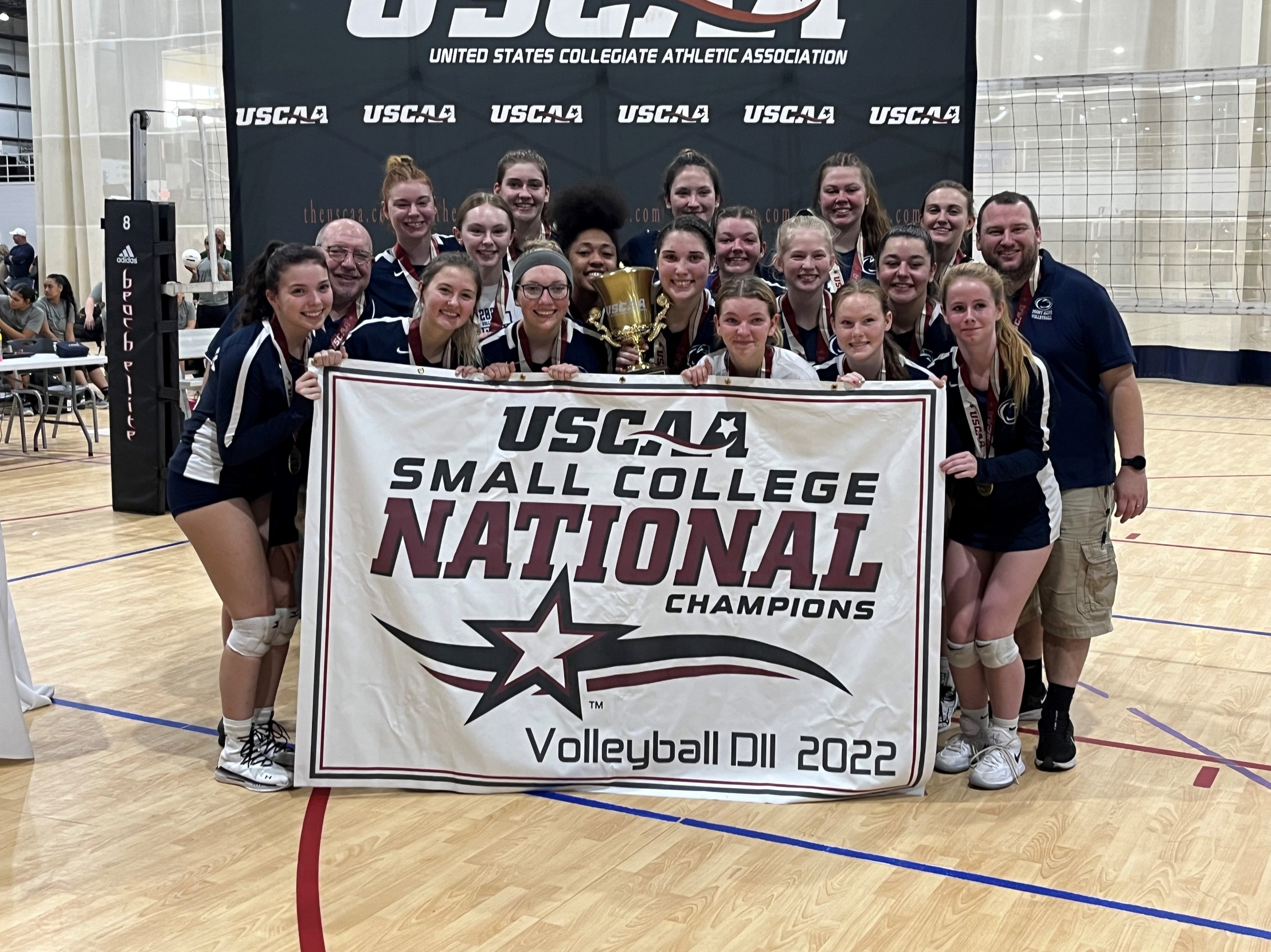 Penn State Mont Alto poses with their 2022 USCAA D2 Volleyball National Championship trophy and banner after defeating Penn State York in the title game in Virginia Beach, Va.